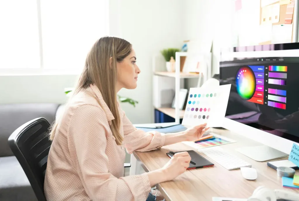 A designer choosing colours for a website layout on a desktop screen
